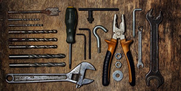 Collection of old tools on a wooden background. The concept of repair and construction work. Old and rusty tools. - Fotoğraf, Görsel