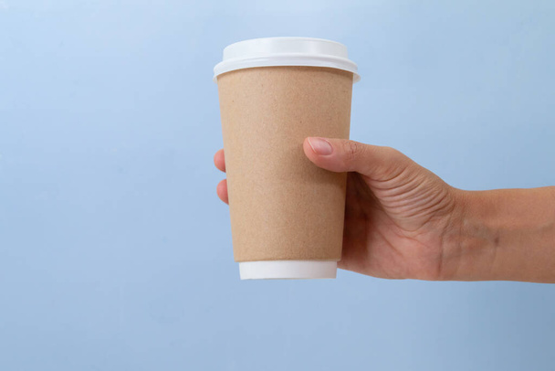 empty paper cup to go against light blue background - Foto, immagini
