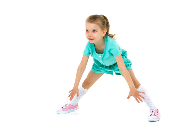 Adorable active little girl doing split on floor - Fotó, kép