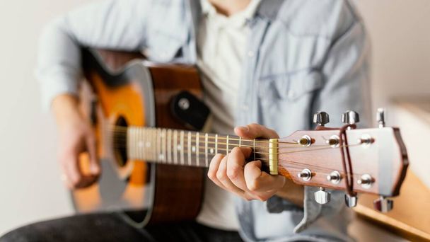 close up musician playing guitar. High quality photo - Foto, immagini