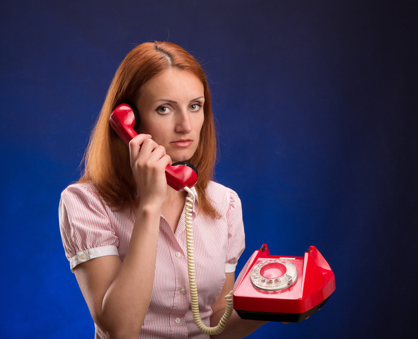 Rothaarige Frau mit rotem Telefon - Foto, Bild