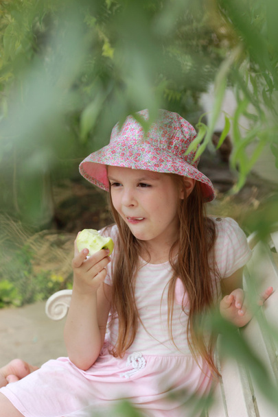 Little girl with green apple - Fotografie, Obrázek