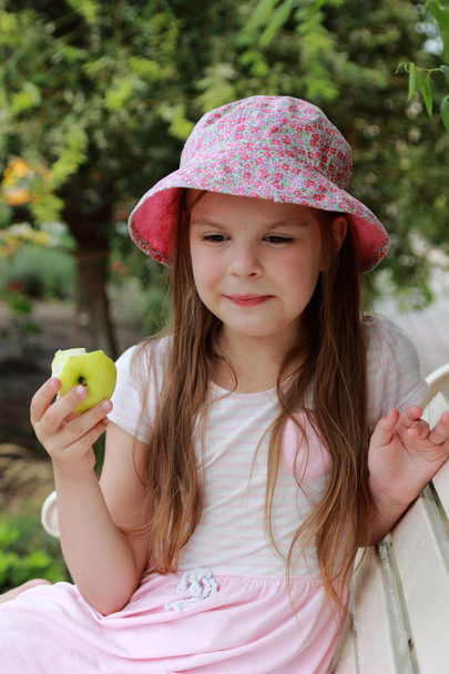 Beautiful little girl with green apple - 写真・画像