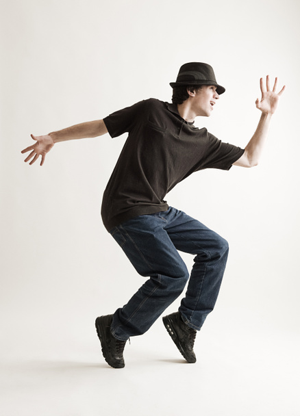 Stylish man in hat dancing - Фото, изображение