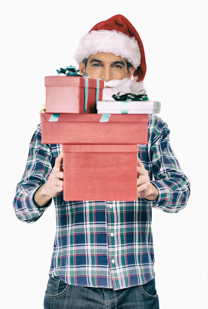 Man holding Christmas gifts - 写真・画像