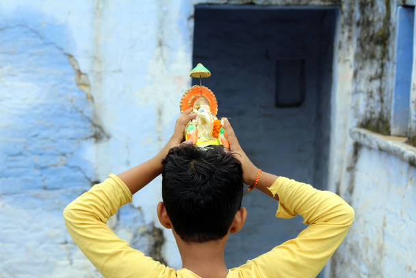 Ένα αγόρι λατρεύει τον άρχοντα Shri ganesha - Φωτογραφία, εικόνα