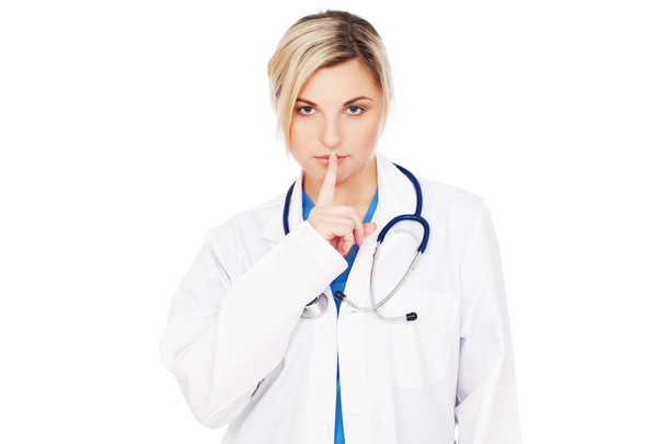 Serious doctor making silence sign - Foto, imagen