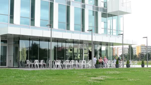 Ravintola ihmisten kanssa - ulkona - modernin rakennuksen edessä
 - Materiaali, video