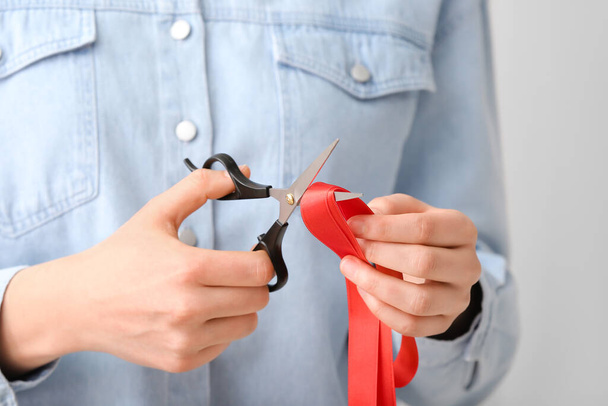 Woman cutting red ribbon, closeup - Zdjęcie, obraz