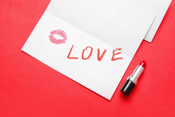 Word LOVE written with lipstick in card on color background, closeup - Fotografie, Obrázek