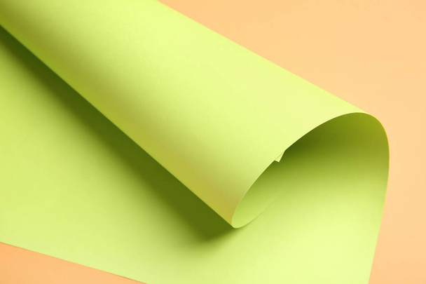 Rolled paper sheet on color background - 写真・画像