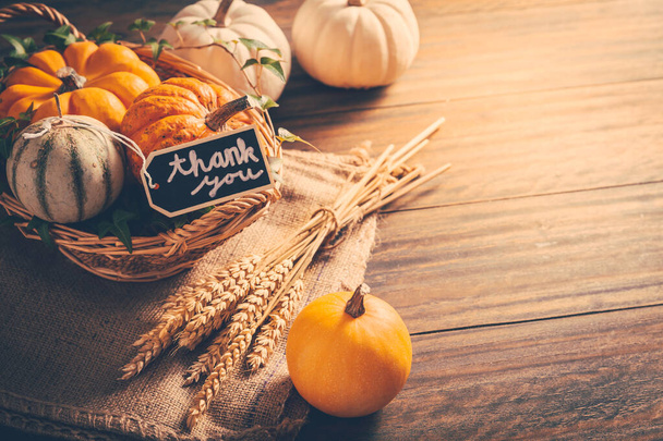 Thanksgiving - still life with pumpkins, ears and autumn leaves on wooden background - Photo, Image