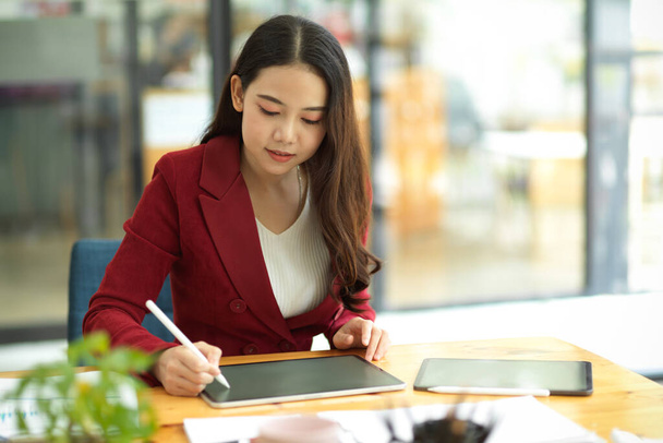 Milenyum iş kadını, masasındaki taşınabilir dijital tablette iş zihin haritası çizmek için stilus kalem kullanıyor. - Fotoğraf, Görsel