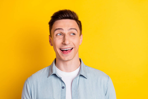 Photo of young cheerful good mood handsome guy look copyspace big sale discount black friday isolated on yellow color background - Photo, image