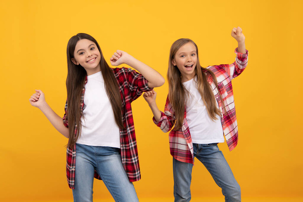 happy kids in casual checkered shirt having fun on yellow background, friendship - Foto, Bild