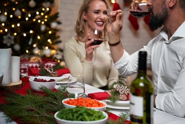 Couple spending good time at Christmas dinner - Фото, зображення
