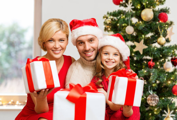 smiling family giving many gift boxes - Foto, imagen