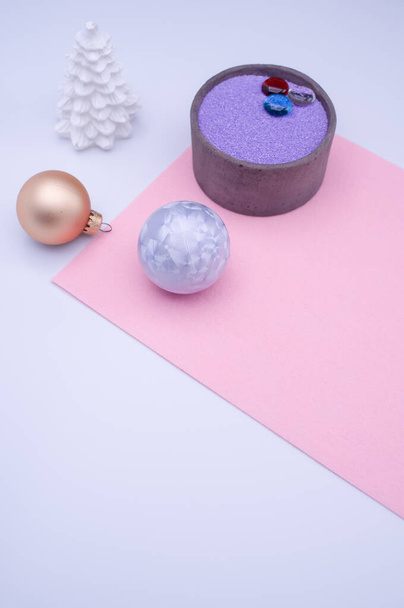 vase with colored sand and Christmas ball decorations on a white background with copy space - Foto, immagini