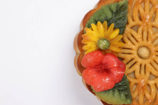 Colorful flower decorated mooncake Chinese mid autumn festival on white background border copy text space - Photo, Image