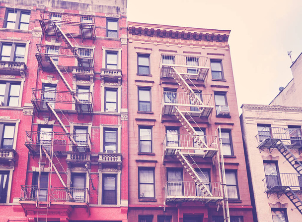 New York townhouses with fire escapes, color toning applied, USA. - Photo, image
