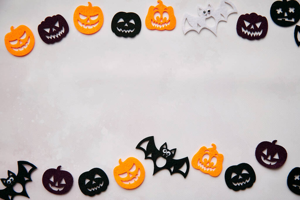 Happy Halloween decorations with bats, cute pumpkins. View from above. Minimalistic holiday concept. Copy space for text. Happy Halloween, trick or treat concept. High quality photo - Фото, изображение