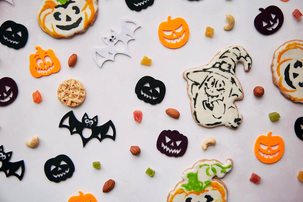 Homemade pumpkin and ghost cookies, Halloween felted decorations with nuts and candied fruits. Autumn holidays concept, Trick or treat. High quality photo. High quality photo. - Photo, Image