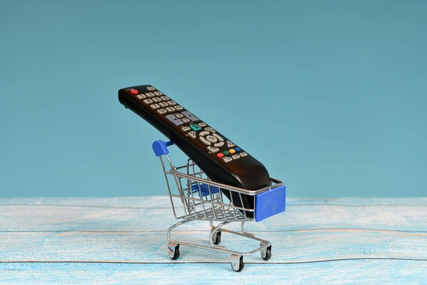 TV remote control in a consumer trolley. Provision of information services. - Photo, Image