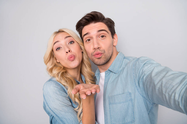 Photo of young lovely couple pouted lips send air kiss shoot selfie isolated over grey color background - Photo, image