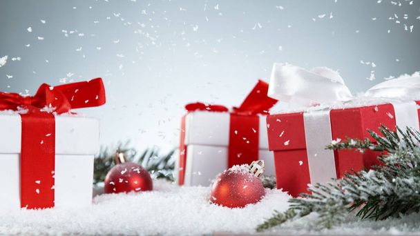 Christmas gits with decorations on snow, free space for text. Celebration and holidays background. - Фото, зображення