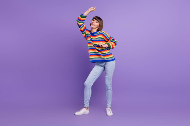 Photo of funky cheerful positive lady dance have fun wear striped sweater jeans shoes isolated violet color background - Zdjęcie, obraz