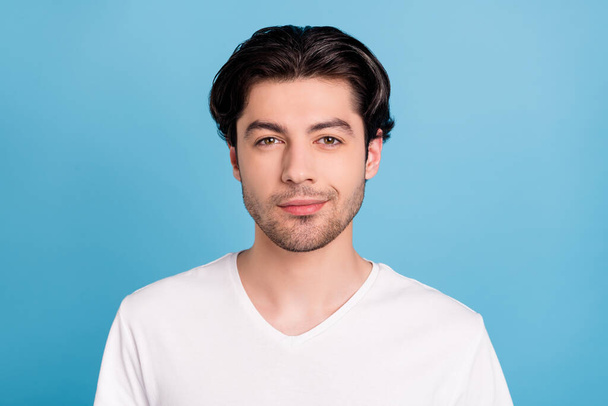 Photo of cheerful positive self-assured guy look camera wear white t-shirt isolated blue color background - Φωτογραφία, εικόνα