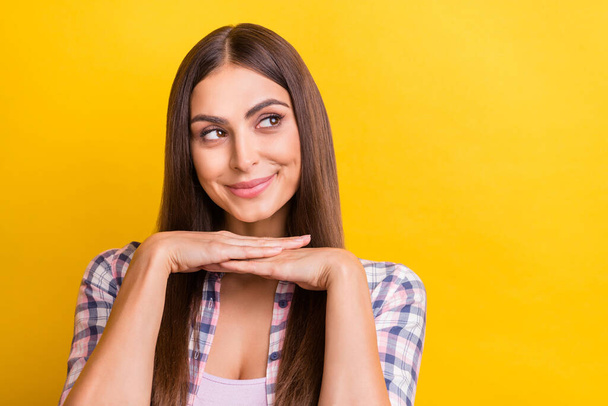 Photo of young attractive woman happy positive smile dream think look empty space isolated over yellow color background - Fotografie, Obrázek