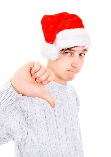 Unhappy Young Man in Santa Hat make Thumb Down on the White Background - Foto, Imagen
