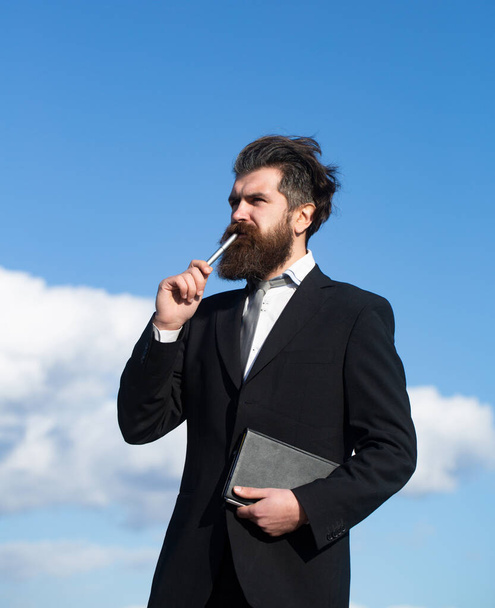 Business man is thinking about something with pencil. Business dreams. Businessman in suit. - Photo, image