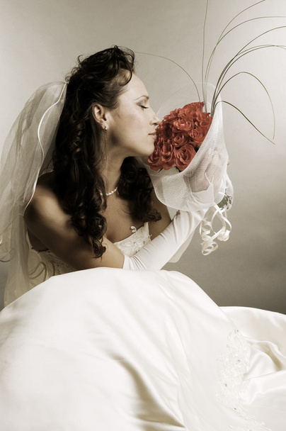 Bride smelling the fragrance of roses - Zdjęcie, obraz