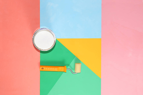 Repair tools, brushes, rollers and paint on a multi-colored painted background. Shop banner, geometry. Minimal renovation and construction concept. Top view, place for text. Trendy green, blue, pink. - Fotografie, Obrázek