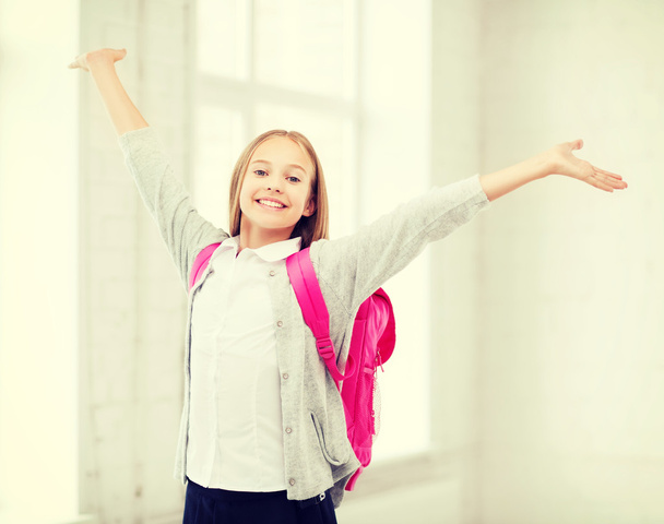 student girl with hands up at school - Foto, Imagen
