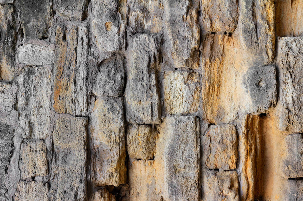 Photo texture of old and ancient stone wall. - Foto, afbeelding