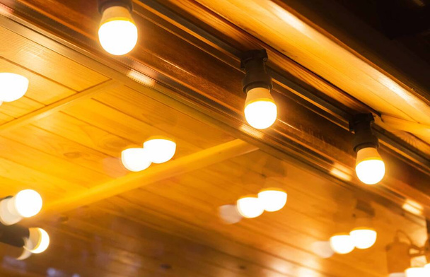 Photo of shining exterior cafe light bulbs. - Foto, afbeelding