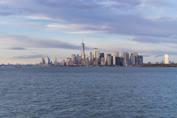 Ferry to Manhattan. View of Manhattan from the water at sunset,  - Фото, зображення
