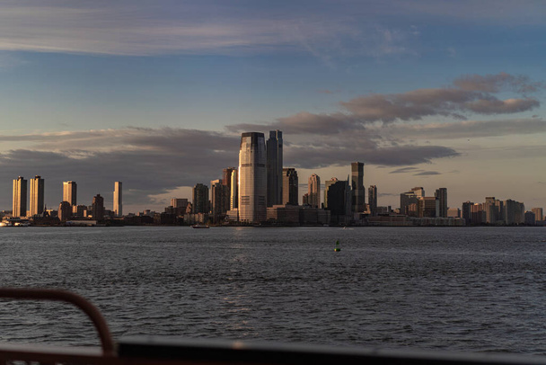 Ferry to Manhattan. View of Manhattan from the water at sunset,  - Fotó, kép
