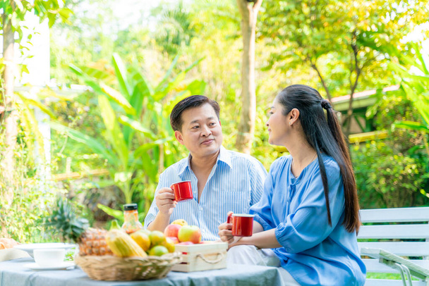 Retirement Senior Couple having coffee and toast in garden morning, Lifestyle Living Concept - Photo, Image