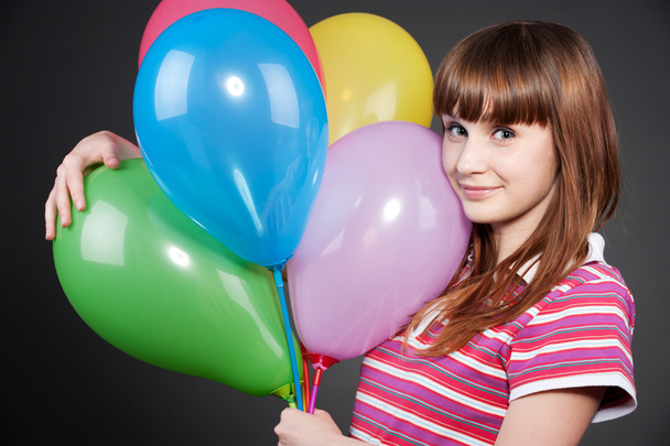Smiley girl with motley balloons - Фото, изображение