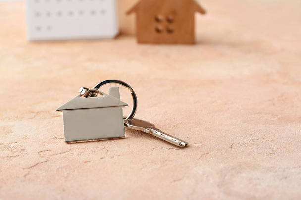 Key with house shaped keychain on color background - Photo, Image
