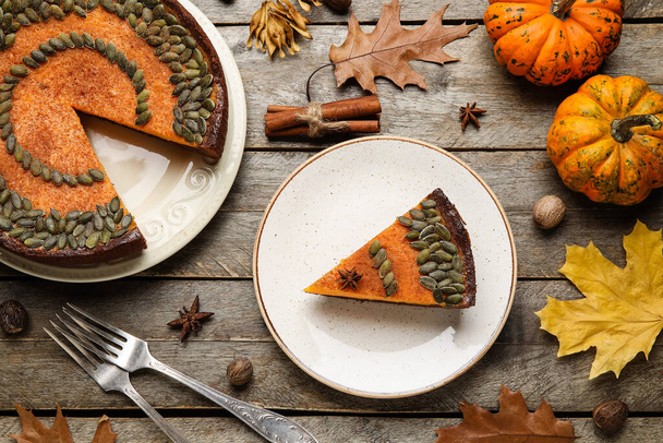 Composition with delicious pumpkin pie on wooden background - Photo, Image
