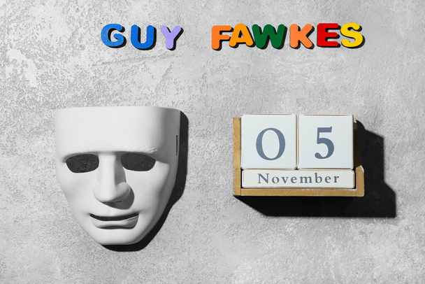 Guy Fawkes maska i kalendarz z datą 5 listopada na grunge tle - Zdjęcie, obraz