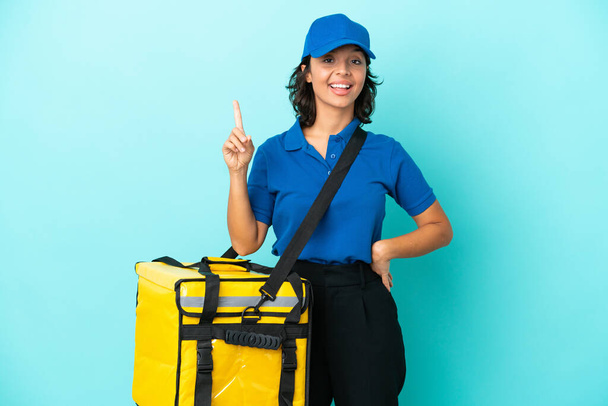 Young delivery woman with thermal backpack showing and lifting a finger in sign of the best - Foto, Imagem