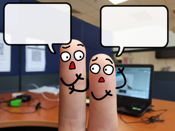 Two fingers are decorated as two person. One of them is discussing about work issue. - Photo, Image