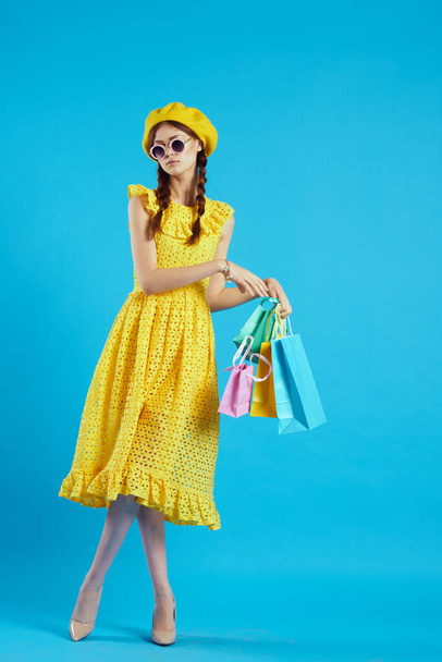 cheerful woman in a yellow hat Shopaholic fashion style studio model - Photo, Image