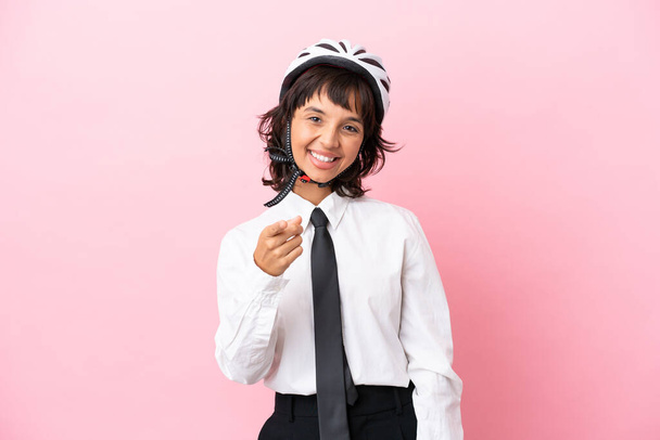 Young girl person with a bike helmet isolated on pink background points finger at you with a confident expression - Photo, Image